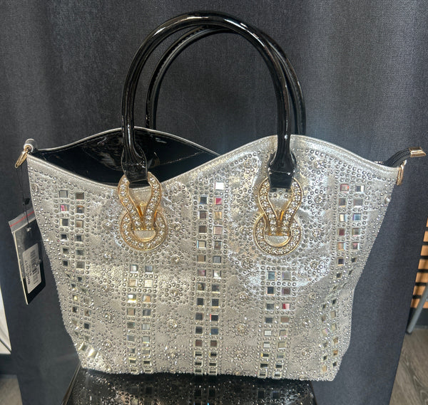 Decorative handbag with intricate design and gold accents on a dark surface