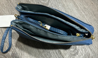 Blue wristlet purse on a wooden surface