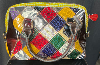 Colorful quilted handbag with a metallic finish on a black surface