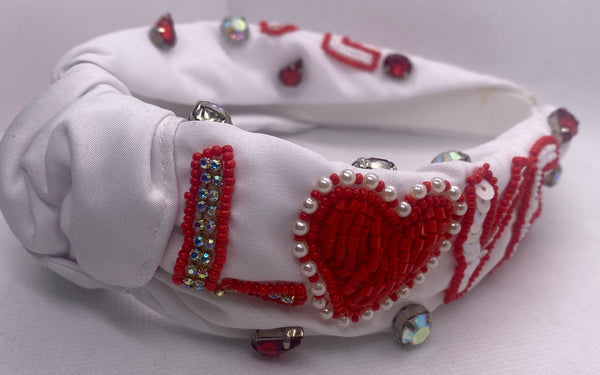 White Love Valentines Day Headband with red and silver embellishments on a white background