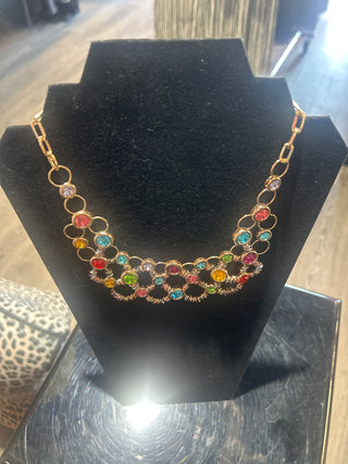 Colorful gemstone Necklace on a black stand with a reflective surface background