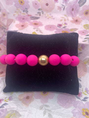 Fuschia Clay Bead with a Gold Tone Bead Stretch Bracelet