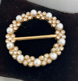Pearl T Shirt Clip on a black cushion with a white background
