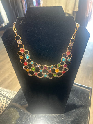 Multicolored beaded Necklace on a black stand with a blurred background