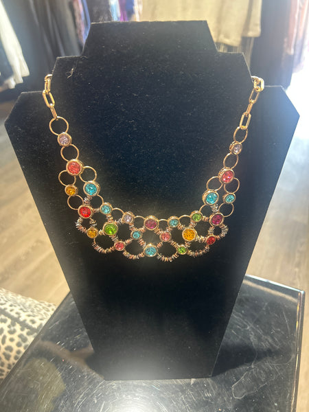 Multicolored beaded Necklace on a black stand with a blurred background