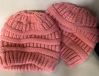Pink knitted hat on a light background