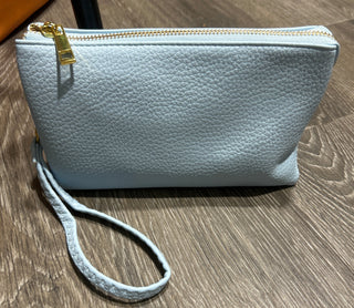 Light blue crossbody bag with a strap can be used as crossbody or wristlet