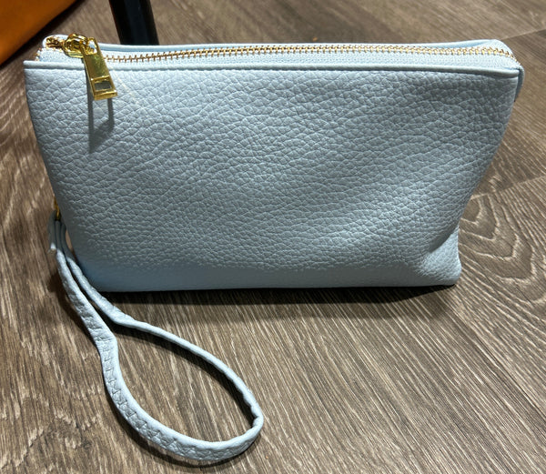 Light blue crossbody bag with a strap can be used as crossbody or wristlet