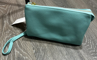 Teal clutch bag on a wooden floor