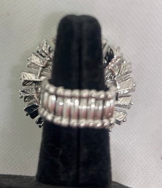 Silver Stretch ring with gemstones on a black velvet stand against a white background
