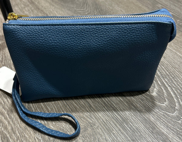 Blue Crossbody Wristlet Purse with a strap on a wooden surface