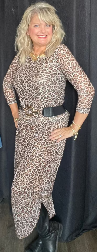 Woman wearing a leopard print dress with a black background