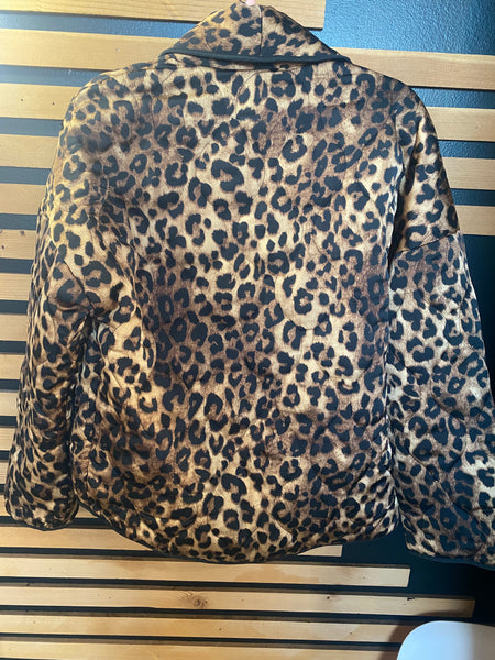 Leopard print jacket on a striped wooden surface