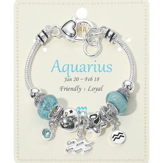 Bracelet with charms on a card labeled 'Aquarius' with details about the zodiac sign.