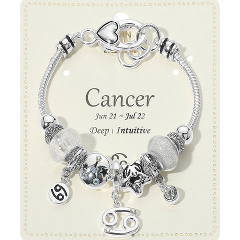 Silver bracelet with charms on a card indicating 'Cancer' zodiac sign