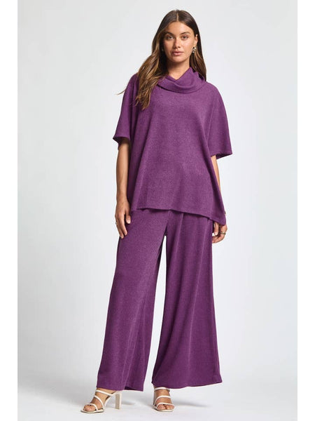 Woman wearing a purple outfit on a white background