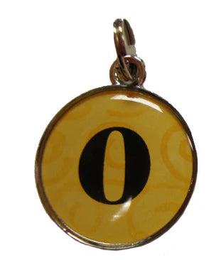 Four circular keychains with different designs on a white background
