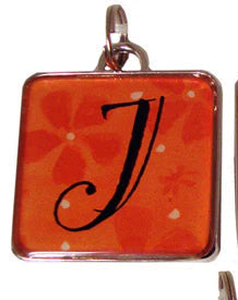 Three square pendants with letter 'J' on a colorful background