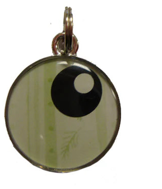 Four circular keychains with different designs on a white background
