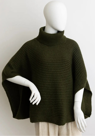 An olive green ribbed knit turtleneck poncho sweater displayed on a white mannequin against a plain light gray background.