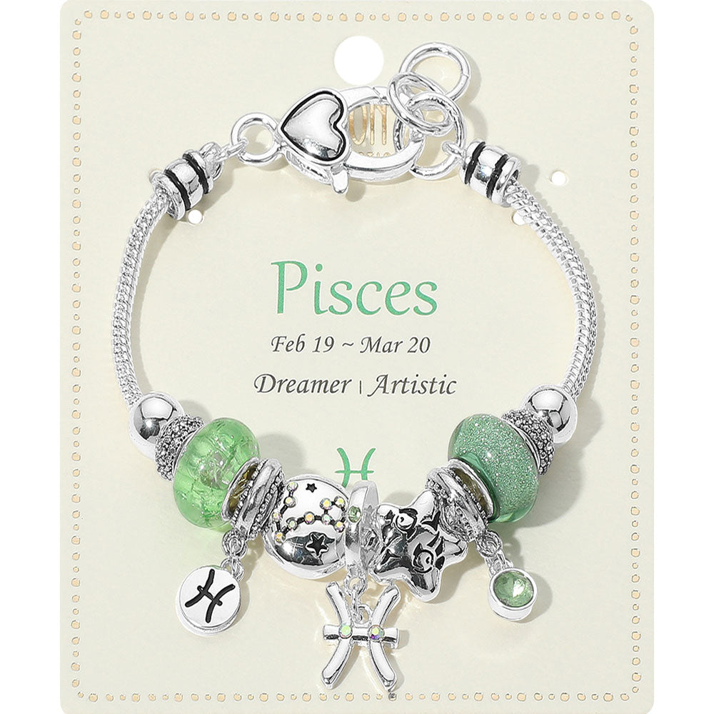 Pisces-themed bracelet with green beads and charms on a matching card