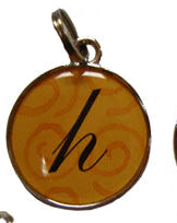 Five colorful pendants with letter 'h' on a white background
