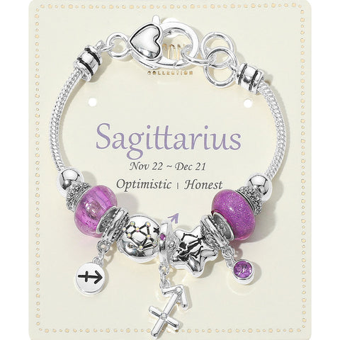 Silver bracelet with purple beads and charms on a Sagittarius themed card