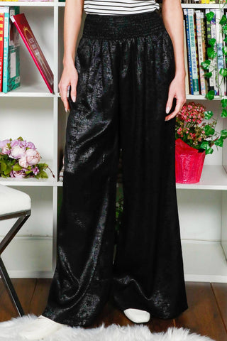 Person wearing black wide-leg pants 