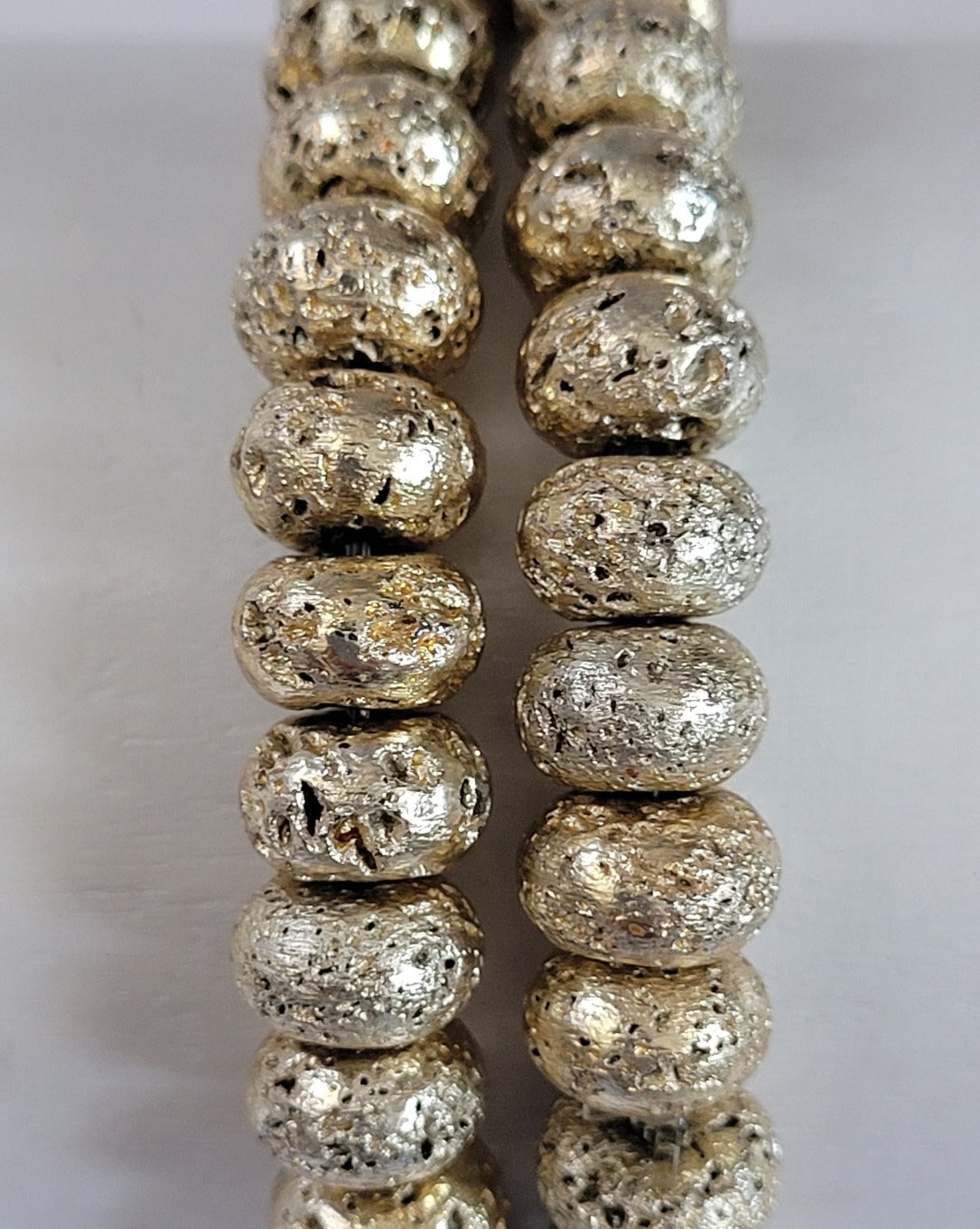 Gold Tone Metallic Oblong Lava Bead Stretch Bracelet